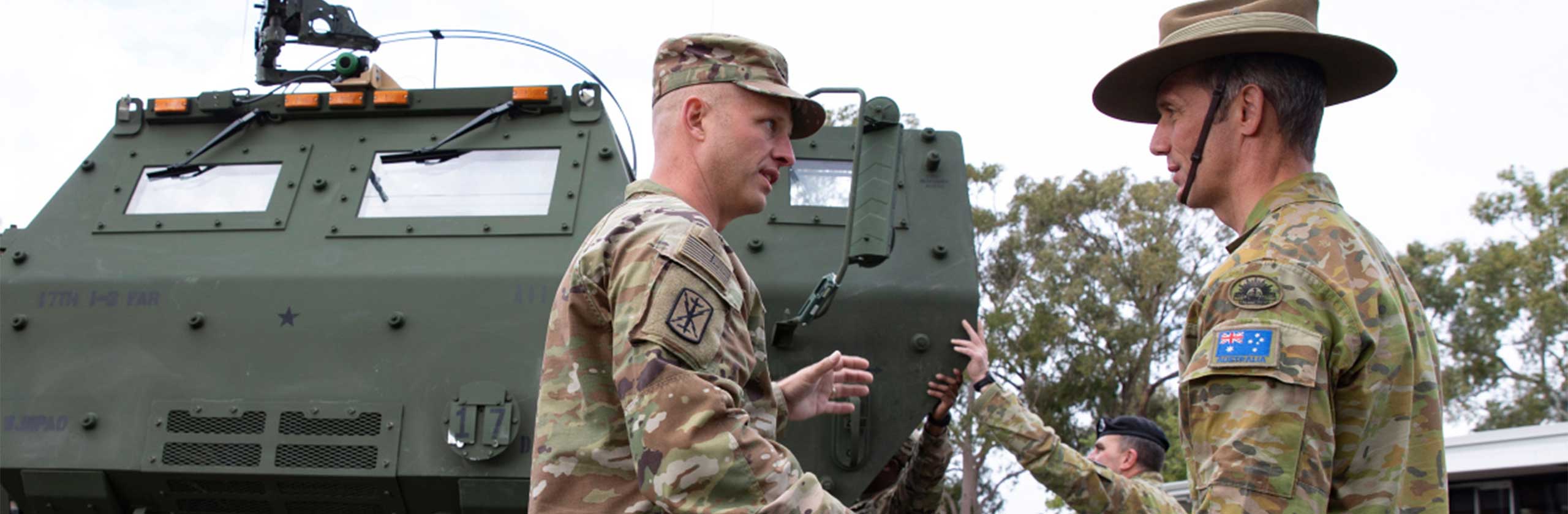 (Left) Colonel Andy Knight, Commander of the US Army’s 17th Field Artillery Brigade, briefs Brigadier Brett Chaloner (right), Commander of the Australian Army’s 13th Brigade, on the capabilities of a US Army High Mobility Artillery Rocket System (HIMARS) launcher during an open day for 13 Brigade members and guests at Irwin Barracks, Karrakatta, near Perth in Western Australia.Two HIMARS launchers from the 17th Field Artillery Brigade are in Western Australia for Exercise HIGHBALL, which will develop how the Australian Defence Force employs long-range land-based precision rocket and missile systems.